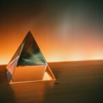 triangular brown and white wooden frame on brown sand during sunset